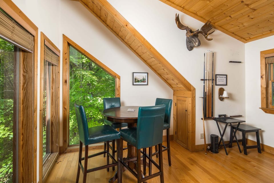Cozy loft seating area with large windows and a peaceful spot to enjoy the mountain setting