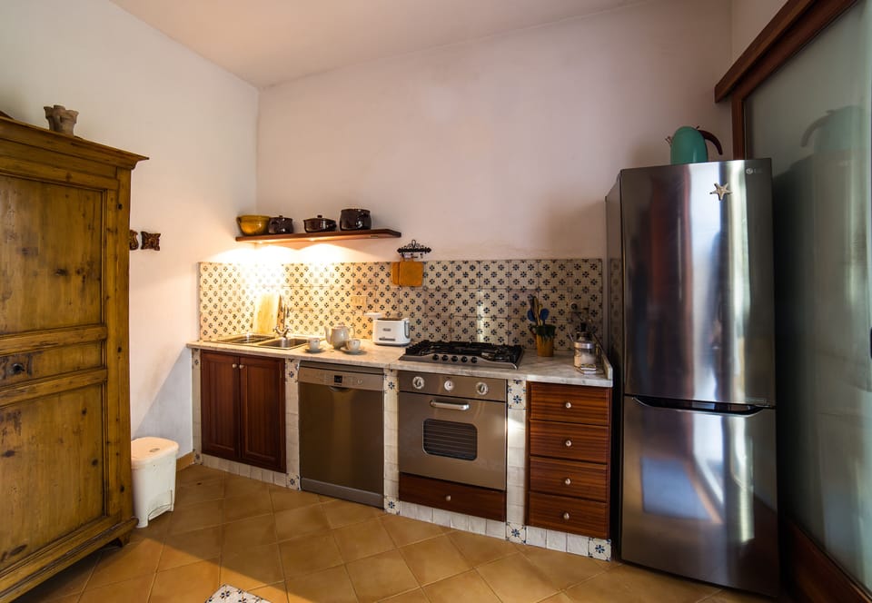 Kitchen with dishwasher, oven, toaster, refrigerator and fridge