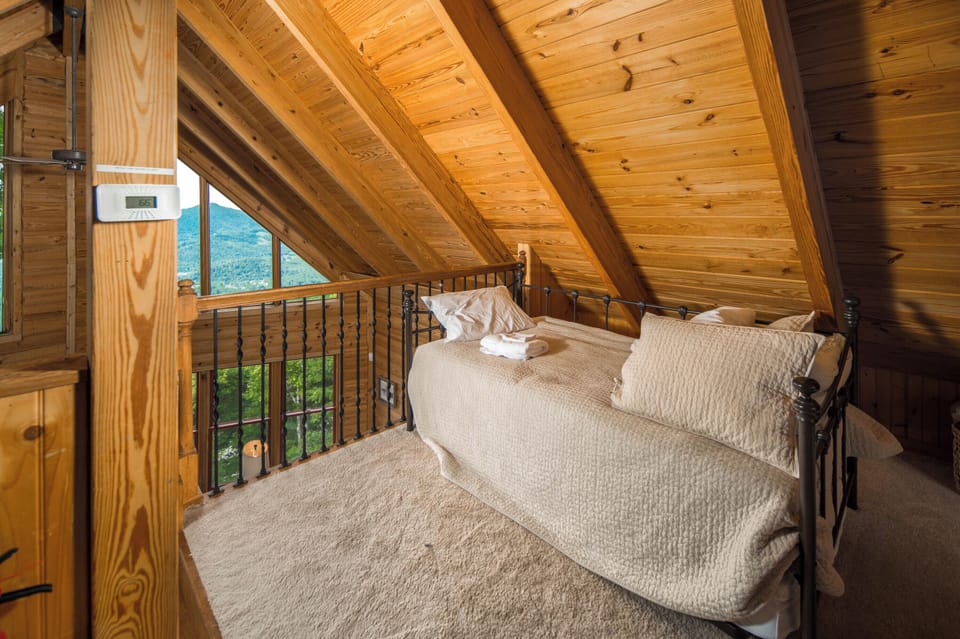 Cozy loft sleeping area overlooking the great room with mountain views