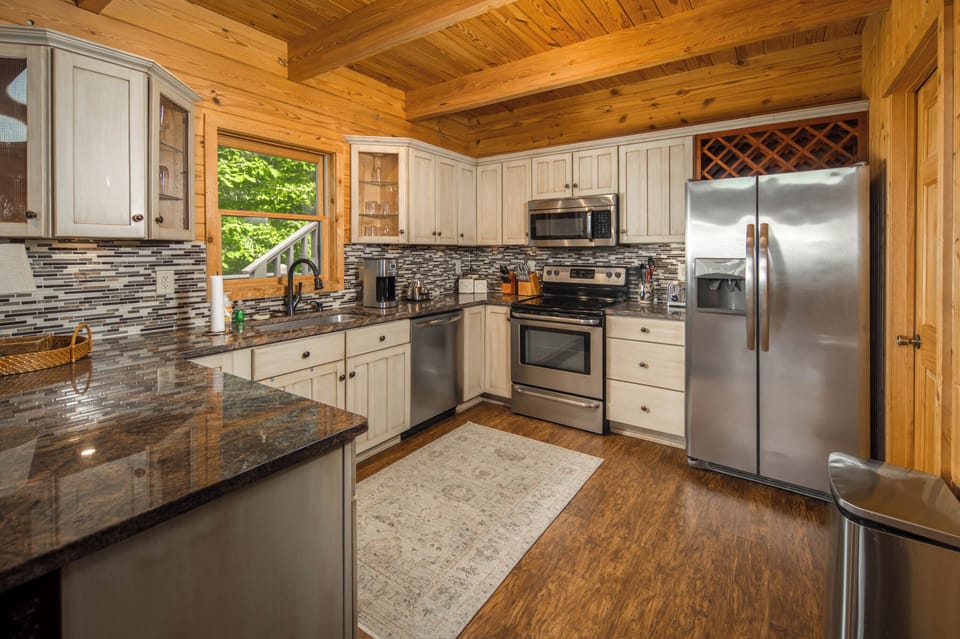 Well-equipped kitchen with granite countertops, stainless steel appliances, and plenty of prep space