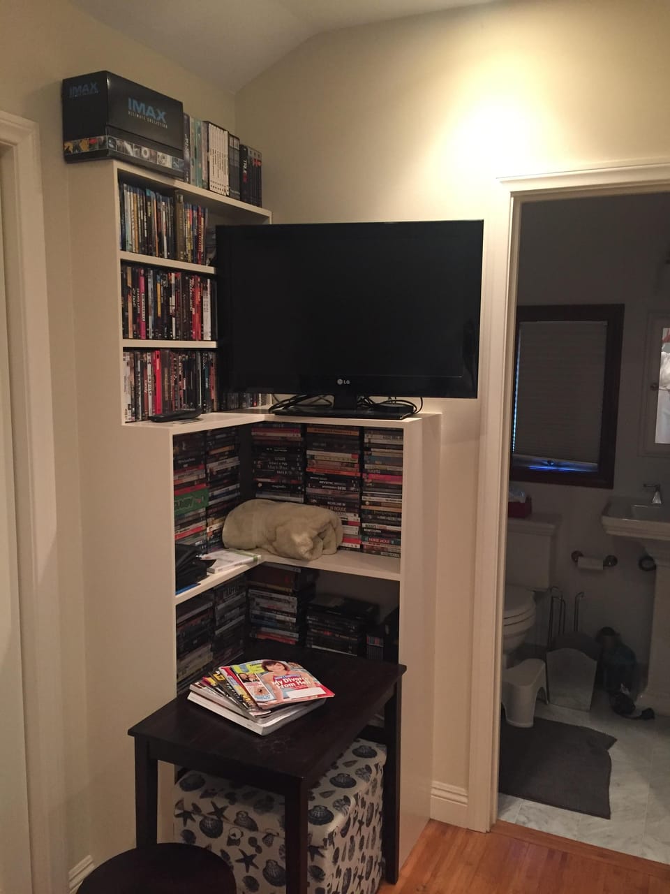 Wall mounted tv - streaming Apple TV and DVD player with huge movie collection. 
