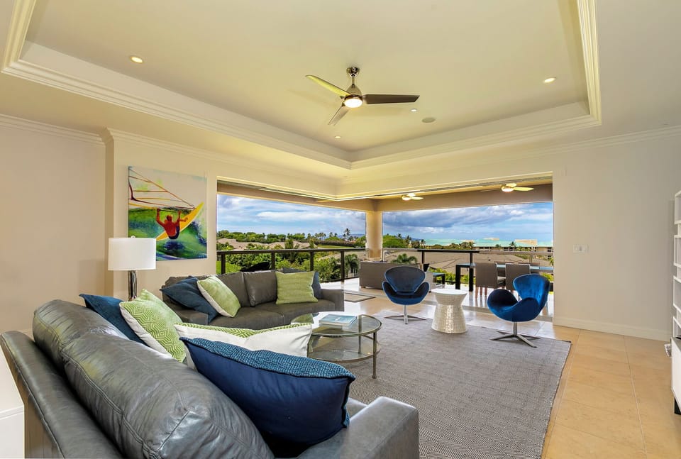 Living room extends out to upper lanai with ocean views