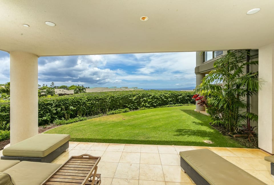 Lower lanai with ocean views and private lawn area