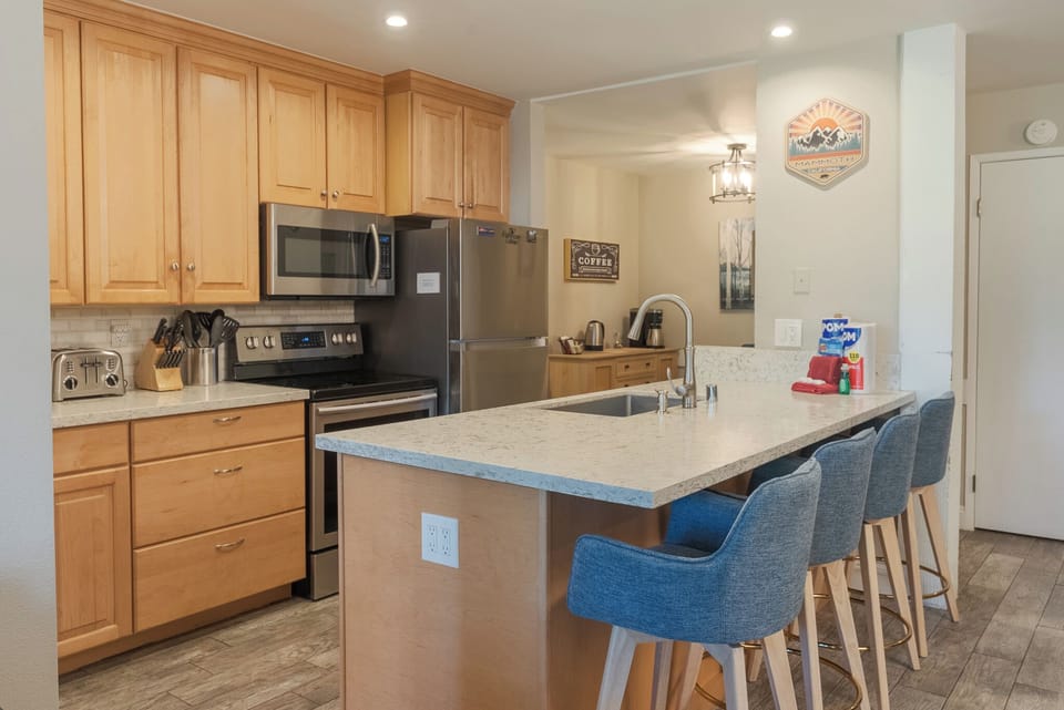 The kitchen is located near the coffee bar (in the background).