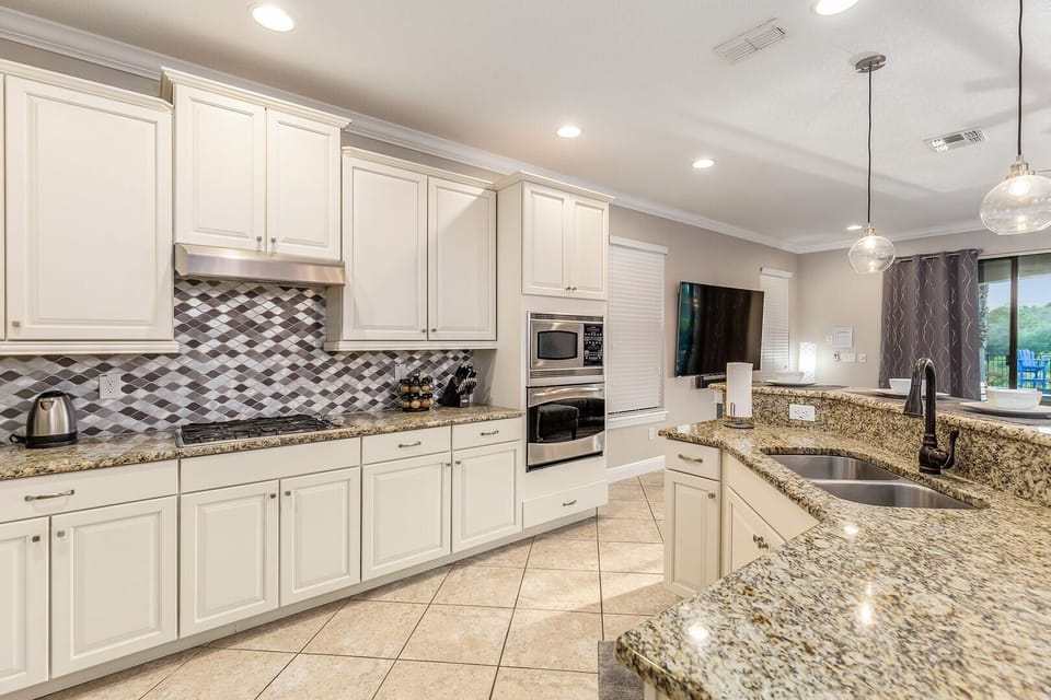 Fully equipped kitchen that features stainless steel appliances