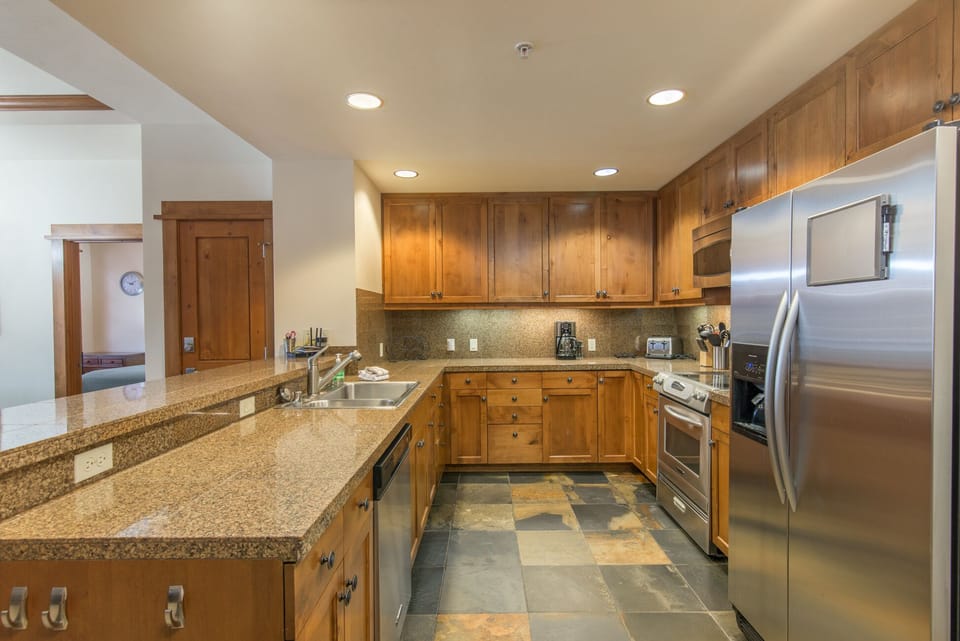 Kitchen open to living area. Granite counter, stainless steel appliances. Clean!