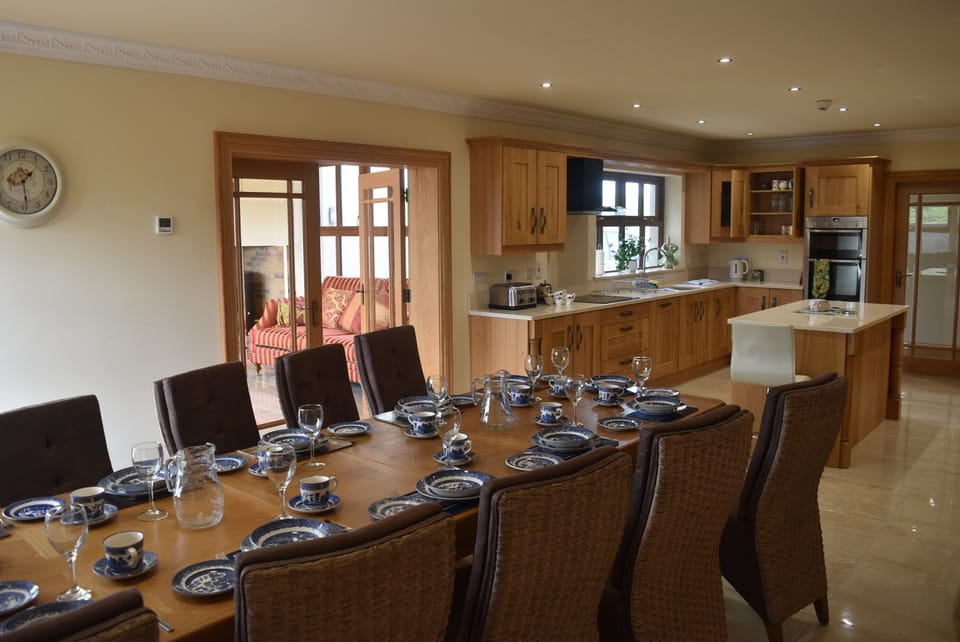 Open kitchen dining area leading to the sunroom