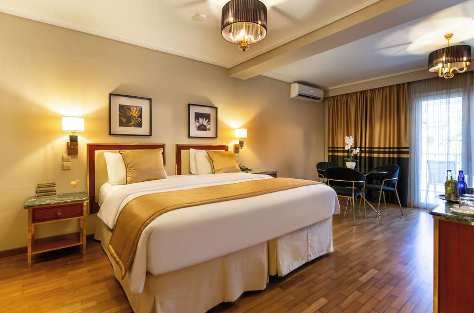 Standard Triple Room, City View | Free minibar, in-room safe, desk, blackout drapes