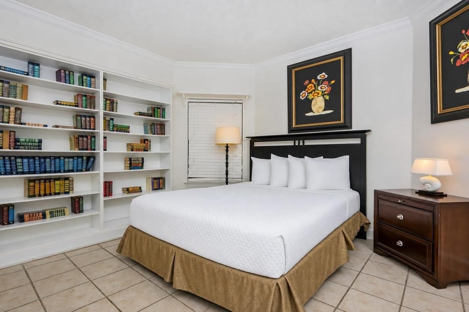 Curl up in the queen bed with your favorite book from the shelf in this serene guest suite, where comfort meets tranquility