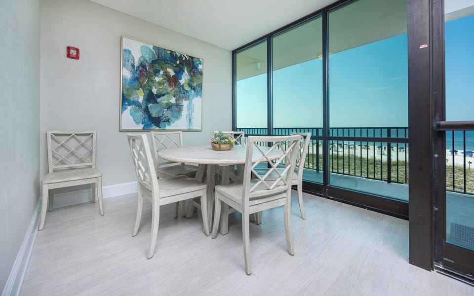 Gather in the lobby with a stunning beachfront view from this bright, airy space featuring a stylish table and cozy seating