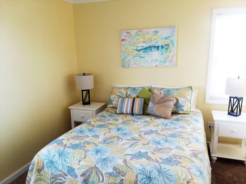 Queen bedroom upstairs on the street side but only a few steps to the beach.