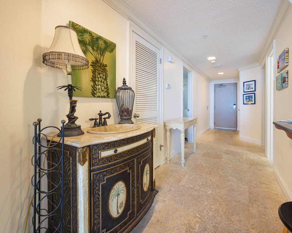 Step into a welcoming hallway featuring elegant decor, unique accents, and a warm atmosphere for your stay