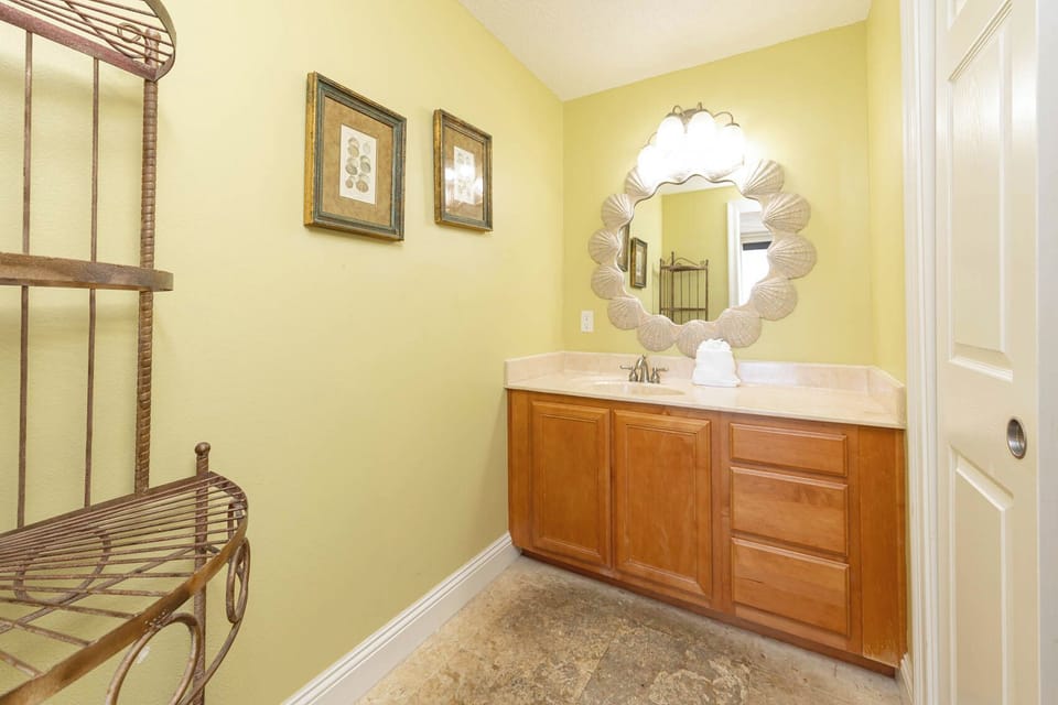 Stylish vanity with a mirror, ample counter space, and charming decor accents