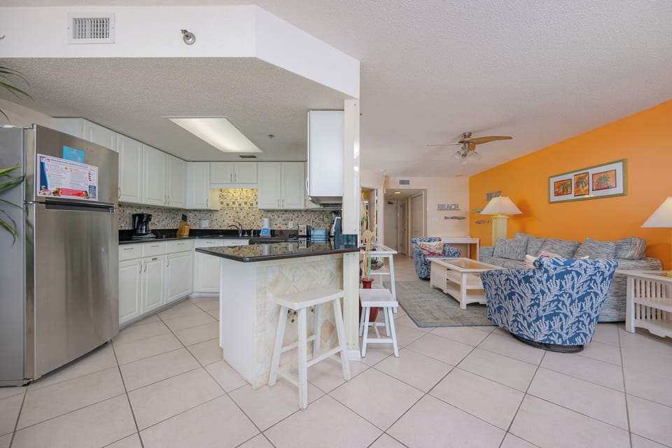 Savor morning coffee at the breakfast bar, enjoying the coastal vibe from your charming kitchen space