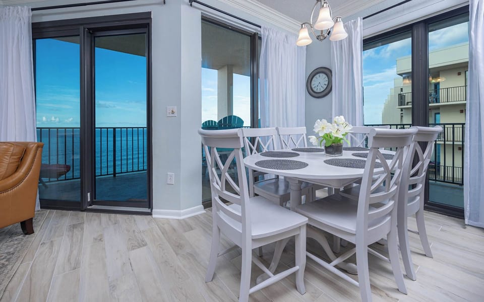 Dine at the round table with floral accents and enjoy views through sliding glass doors leading to the balcony