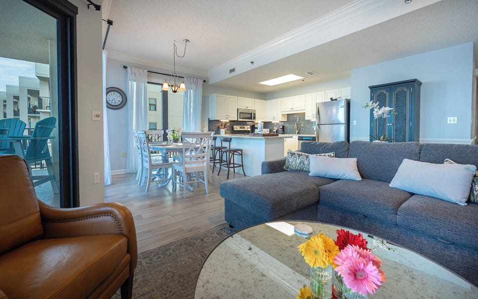 Unwind in the spacious living area with a comfortable sofa, stylish decor, and a dining space bathed in natural light