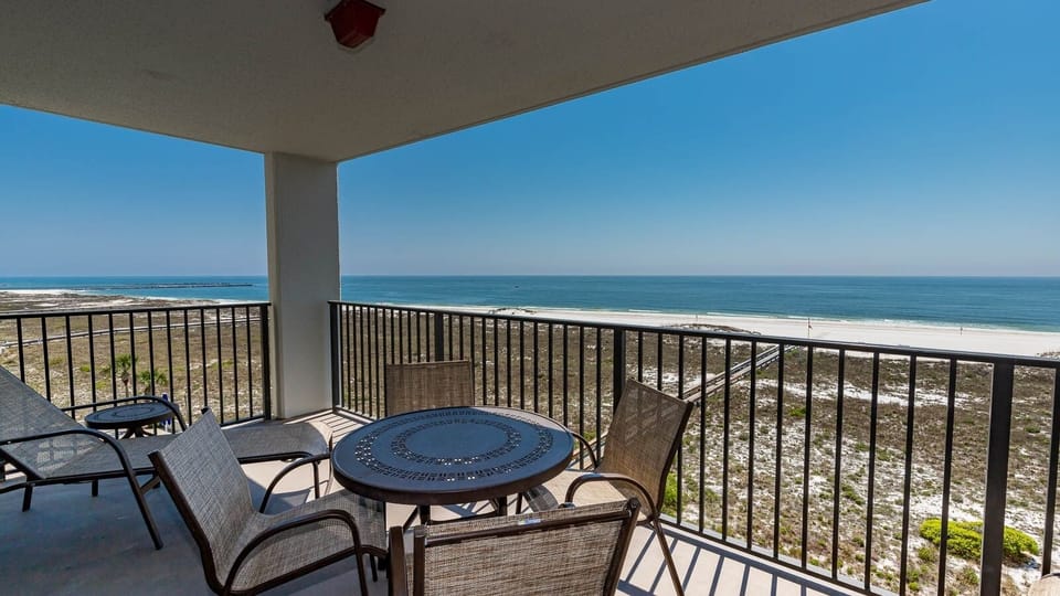 Balcony seating offers a serene view of the tranquil gulf and the nearby beach, perfect for relaxing moments outdoors
