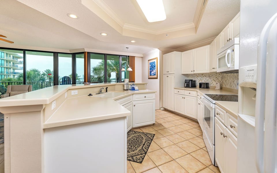 Bright kitchen lets you prepare meals while spotting palm trees and glimpses of the view beyond your balcony
