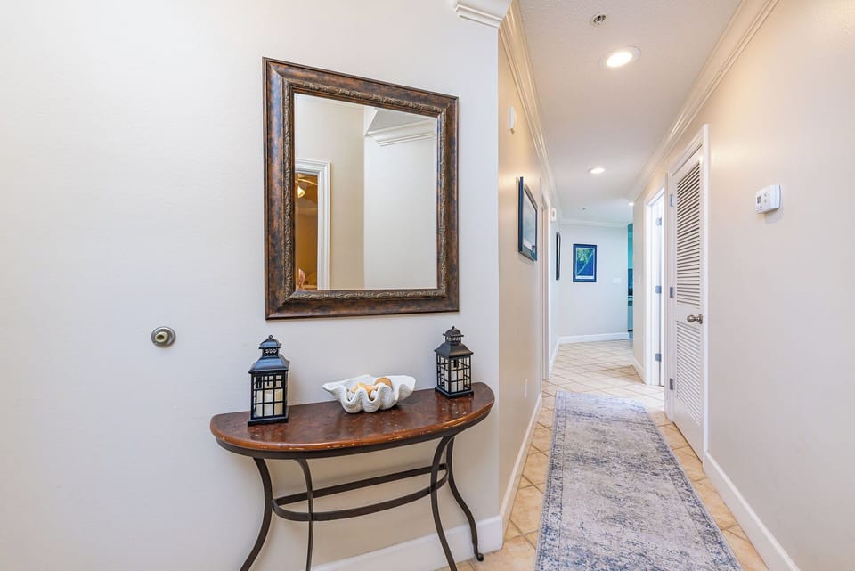Warm lighting guides you through the entryway where coastal accents hint at your getaway ahead