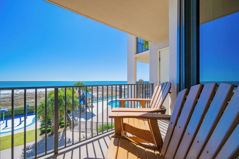 Relax and soak in the coastal vibe from your balcony while enjoying views of the pool and lush surroundings