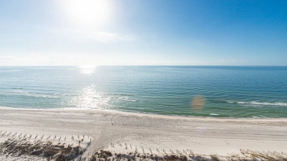Bask in the sun while enjoying serene views of the gentle waves and expansive shoreline from your balcony