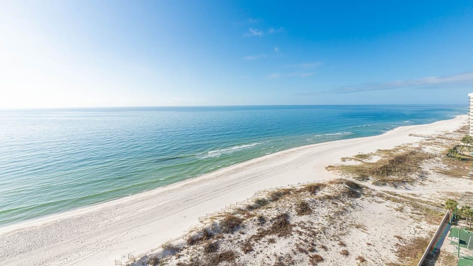 Gaze at the serene water and expansive shoreline, perfect for relaxation and enjoying nature's beauty