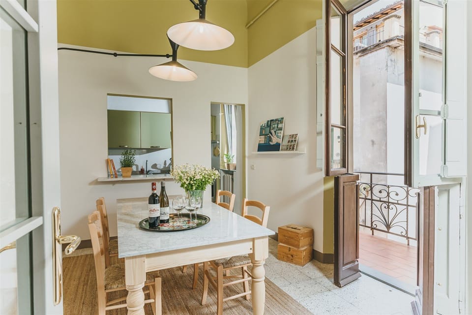 Dining area, balcony (right) and kitchen (front)
