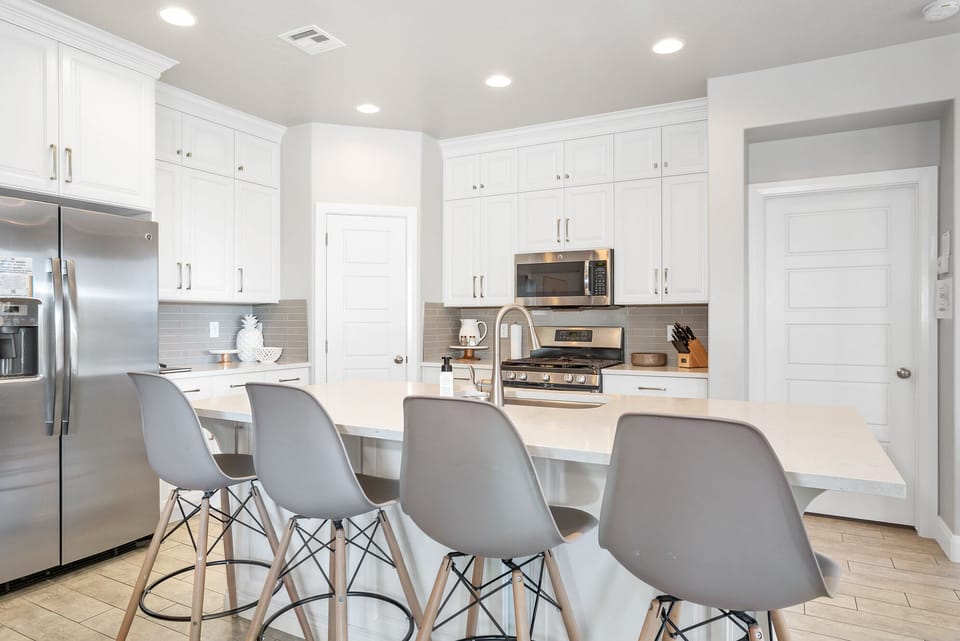 Fully stocked gourmet kitchen featuring extra seating at the bar