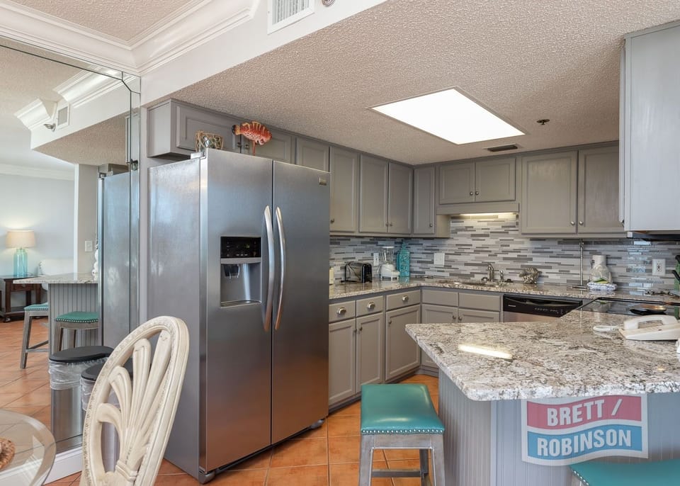 Prepare meals in the spacious kitchen, featuring stainless appliances and a stylish countertop for casual dining