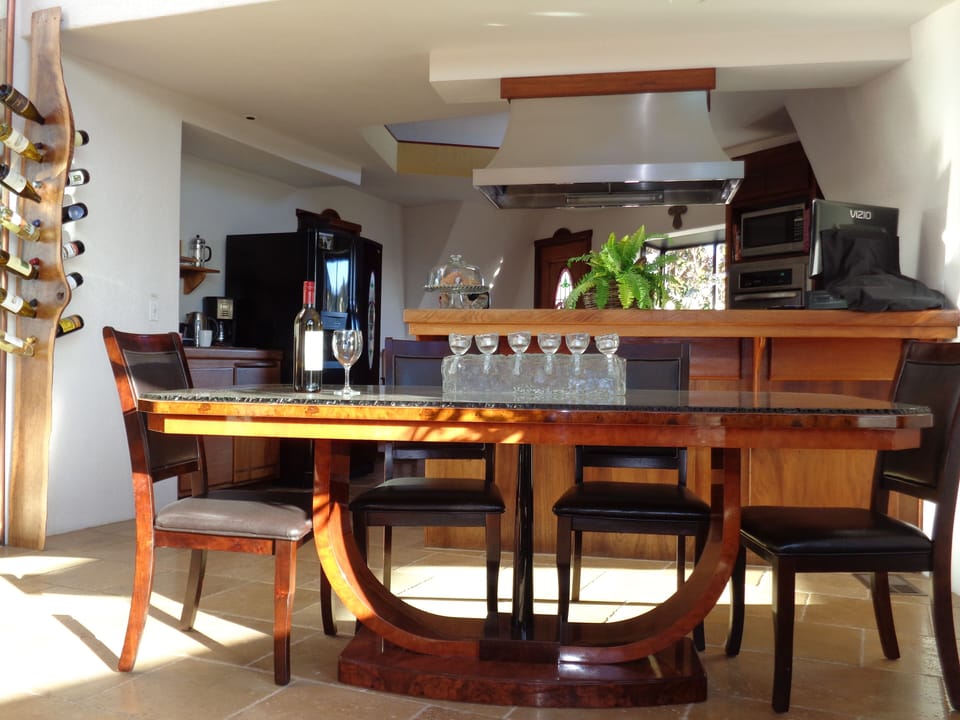 Dining ready for up to 8, between living and kitchen, all open plan.