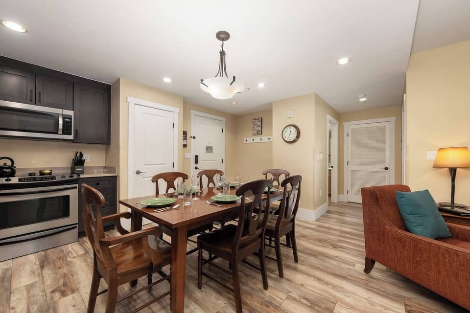 Open concept kitchen, dining and living area with gas fireplace, flat screen TV, pull-out sofa and views of the slope