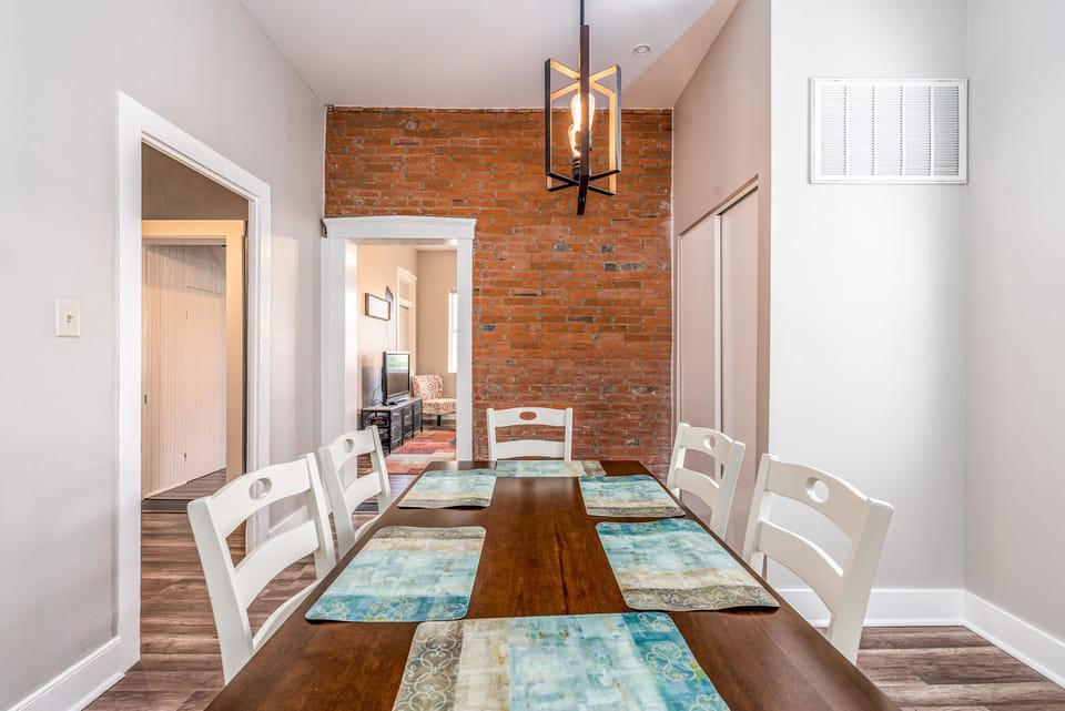 Dining area has historic feel with the original brick wall still intact.