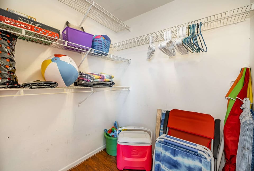 Second bedroom walk-in closet with beach supplies