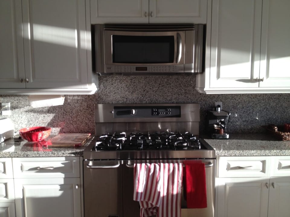 Renovated kitchen with granite countertops and access to lakeside patio!