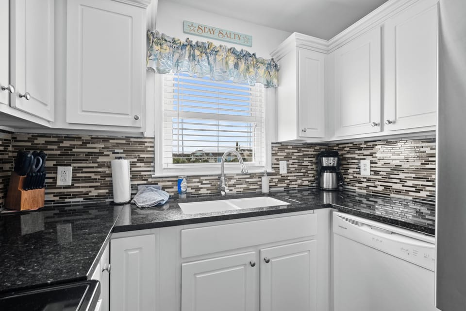 Kitchen with granite countertops and tile backsplash. USB speed hookups for tech