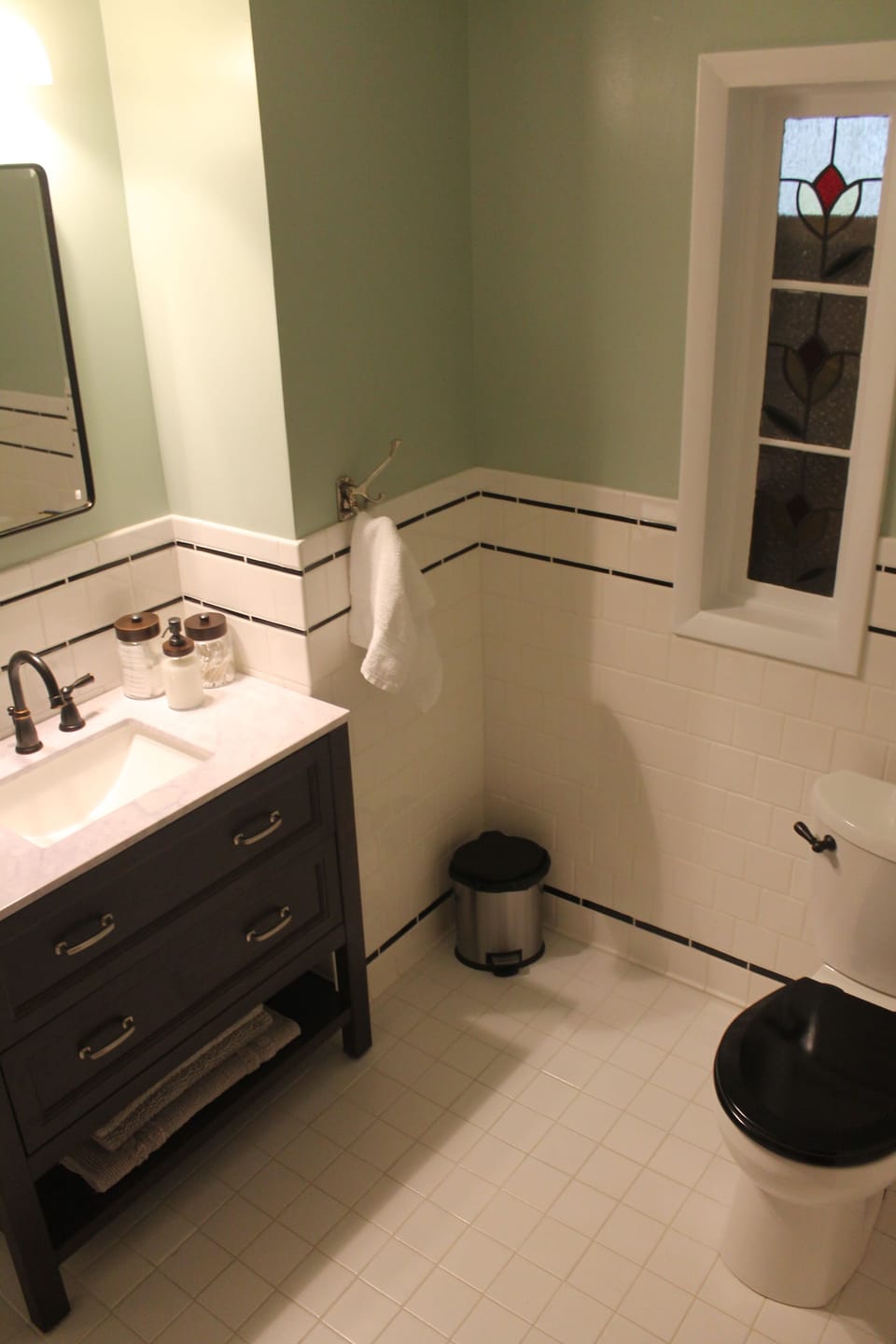 Classic black and white bathroom with tub and shower.