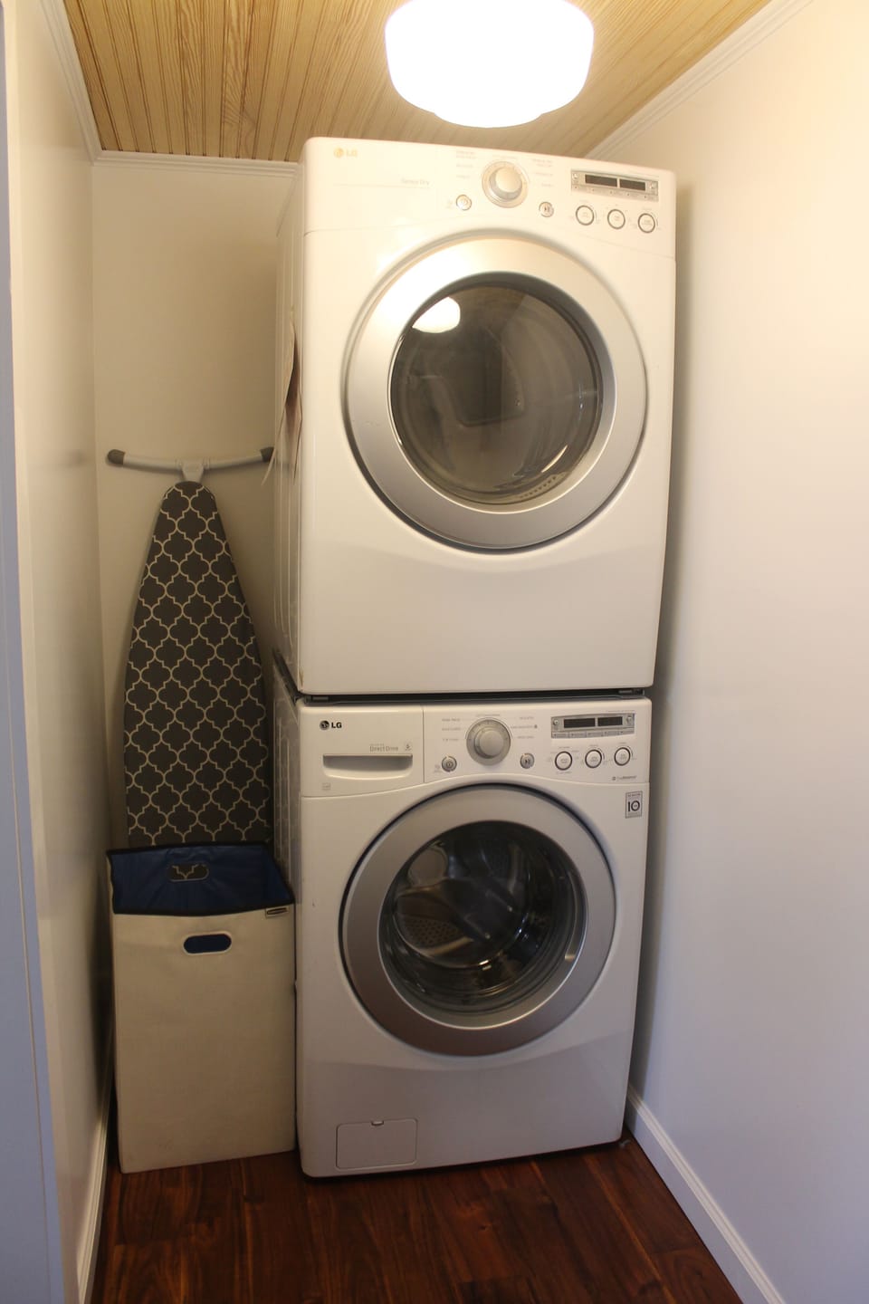 Laundry room has iron, steamer, tide, and fabric softener as well.
