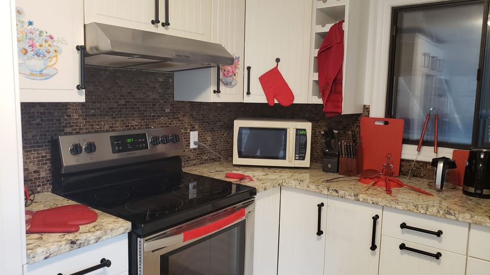 Some of the kitchen's amenities, such as stove and microwave.