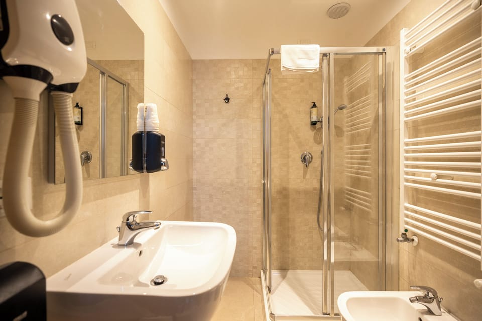 Basic Quadruple Room, Canal View | Bathroom | Shower, hair dryer, towels, soap