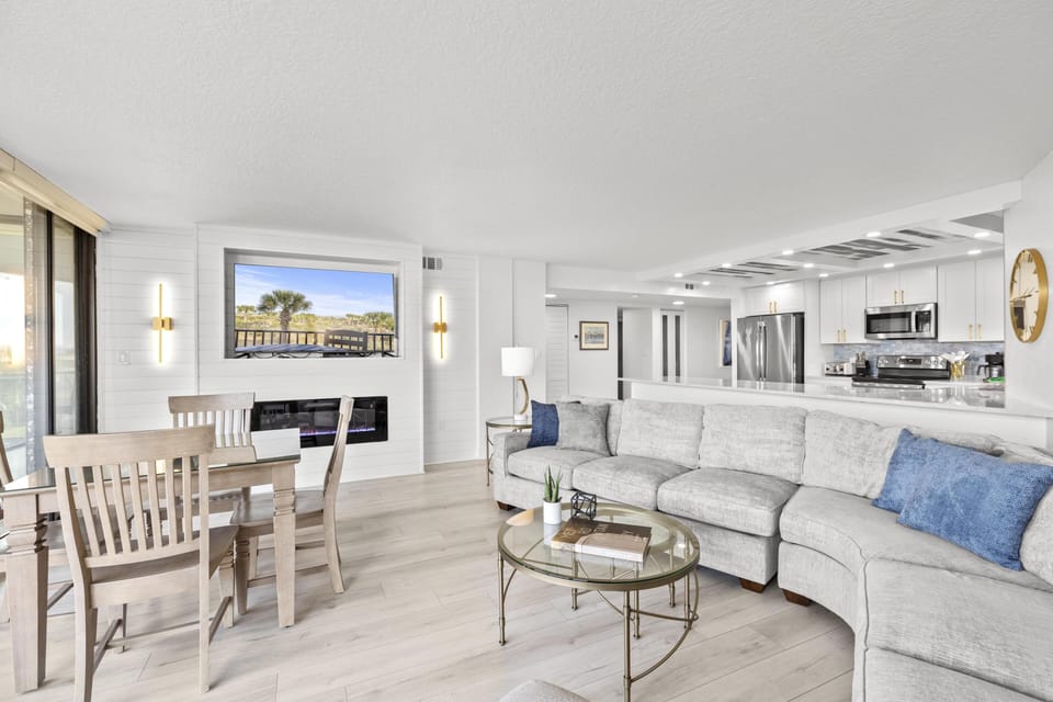 Open concept floor plan. Bright and airy living room with cozy sectional and ocean views.