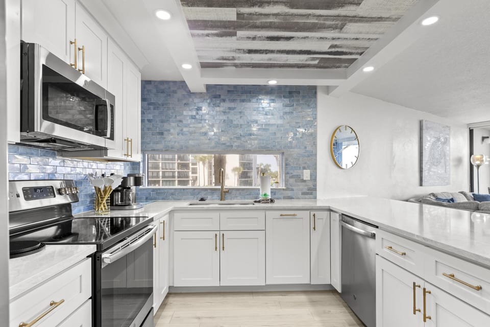 Bright, modern kitchen with microwave dishwasher and stylish backsplash