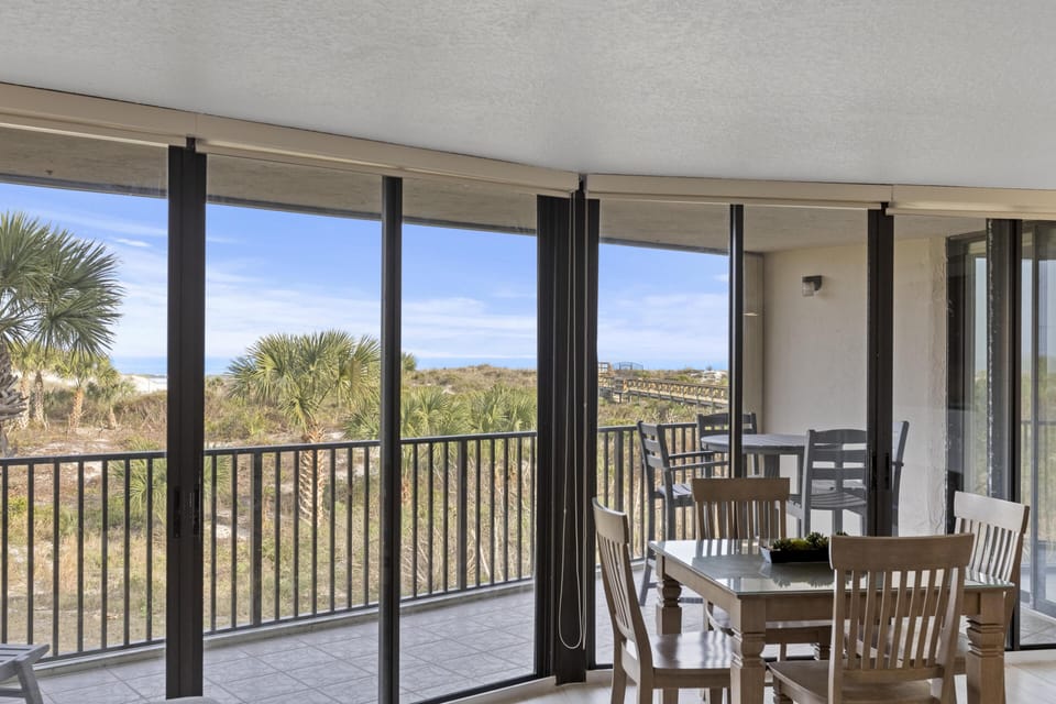Spacious oceanfront balcany with scenic views and dining area