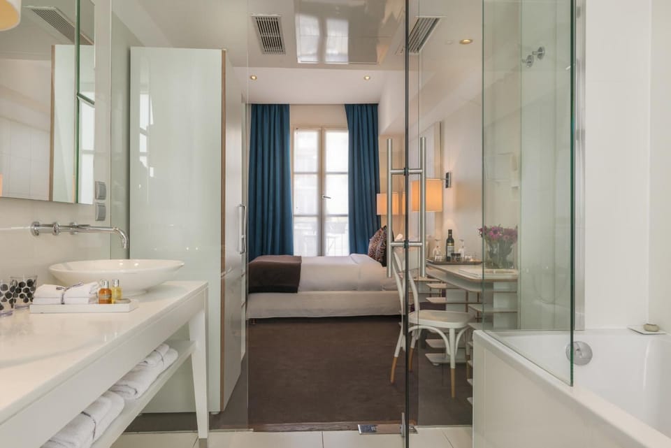 Bathtub, designer toiletries, hair dryer, bathrobes