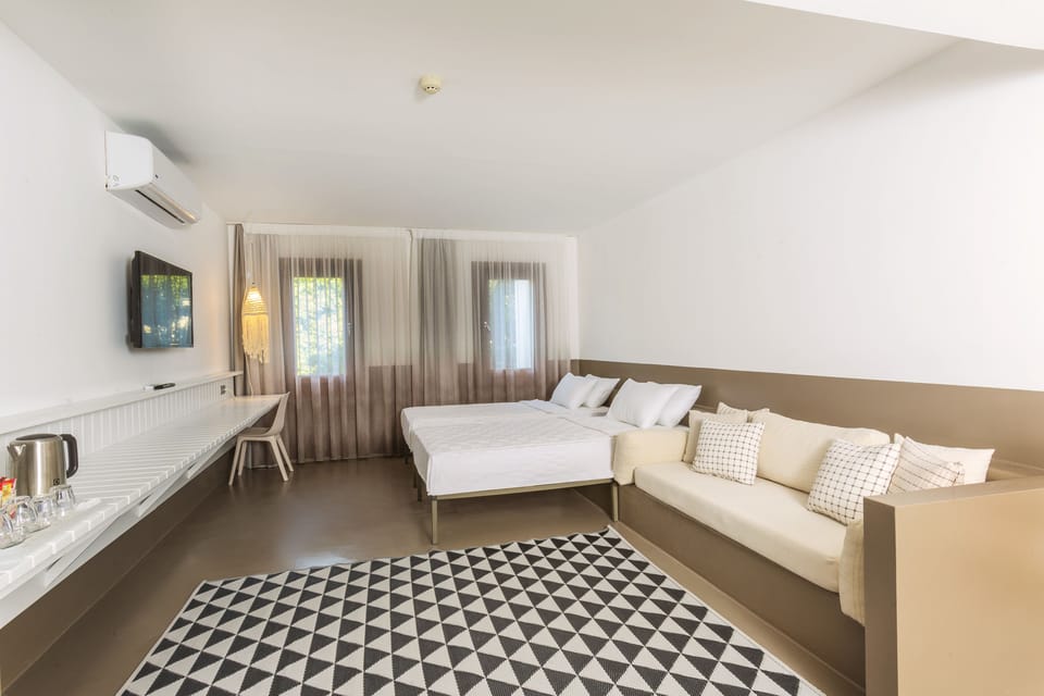 2 Bedroom Deluxe Room, Balcony, Pool View | Minibar, in-room safe, desk, laptop workspace
