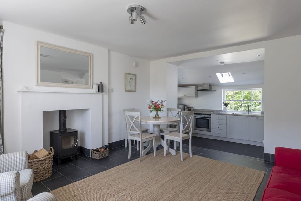 Garden Cottage, Teviot Bank - the dining area with wood burner and circular table