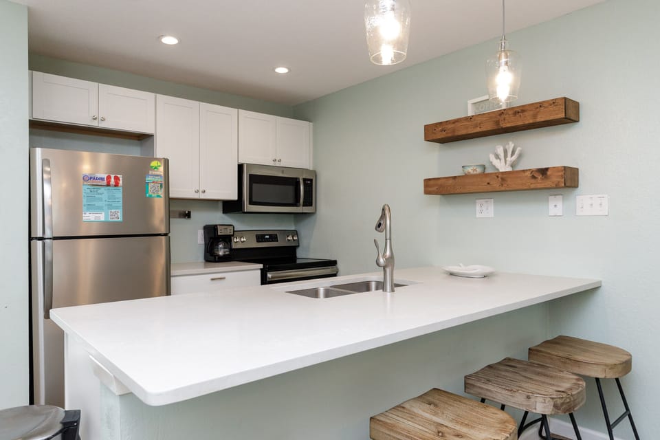 Your modern kitchen features stainless steel appliances, quartz countertops, and charming wood accents for memorable meal prep.