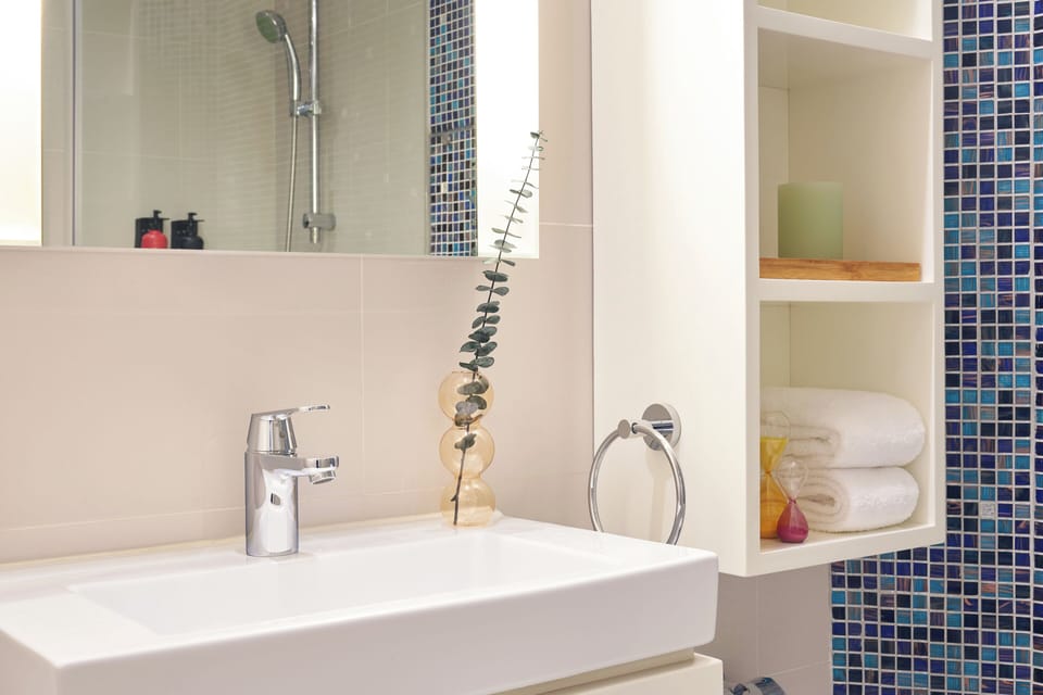 Shower, hair dryer, slippers, towels