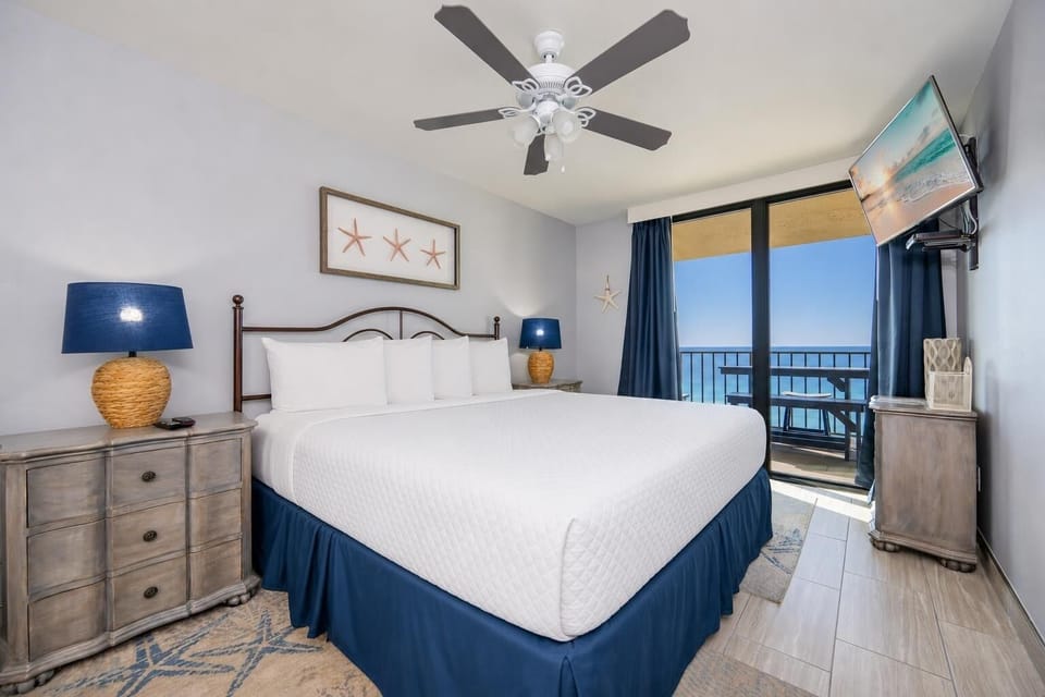 King master suite invites restful sleep while you unwind and glimpse the coast from the balcony