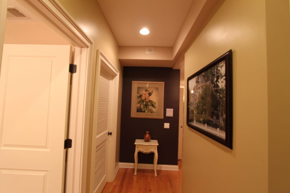 The front hall bathroom to the left. This hall leads to the private bedroom hall