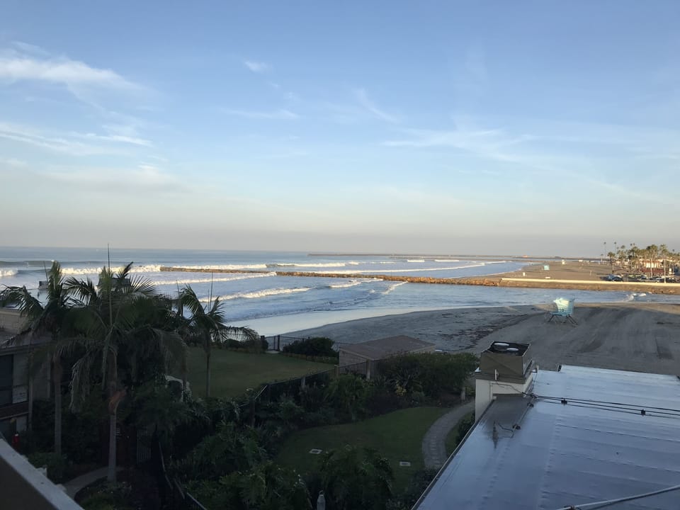 Steps from the beach!  The view from the balcony at high tide.